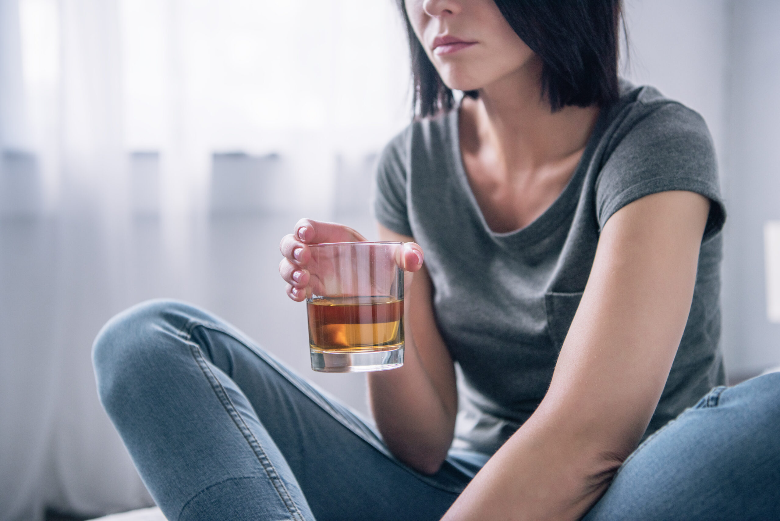 Unhappy Woman Holding a Glass of Alcohol